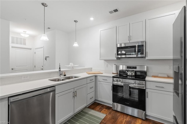 kitchen featuring light countertops, visible vents, stainless steel appliances, and a sink