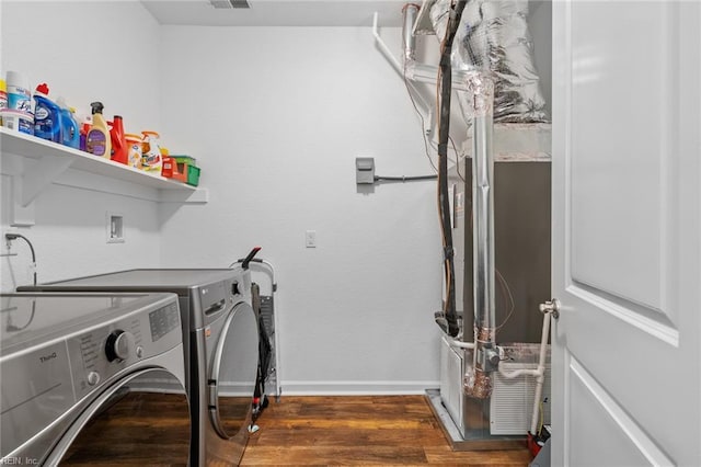 laundry area with baseboards, visible vents, separate washer and dryer, wood finished floors, and laundry area