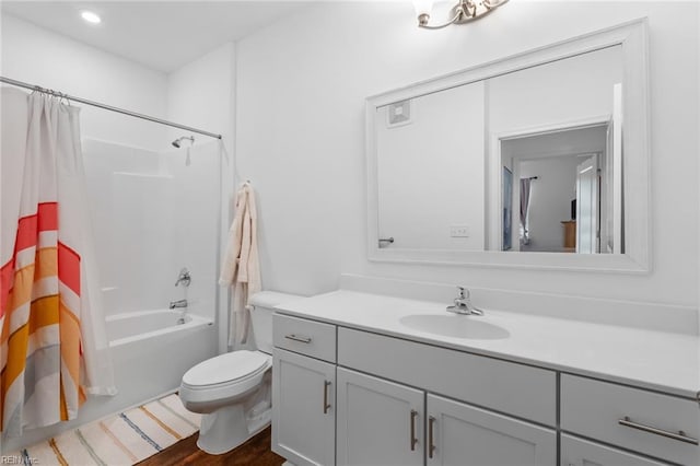 bathroom featuring wood finished floors, vanity, shower / tub combo with curtain, toilet, and recessed lighting