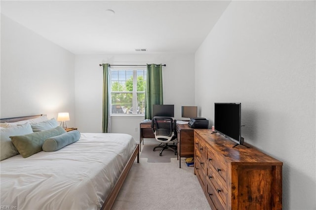 bedroom with light colored carpet