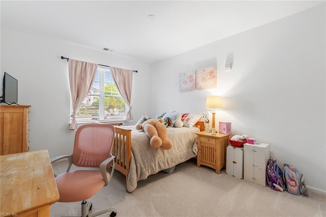 bedroom with visible vents and carpet