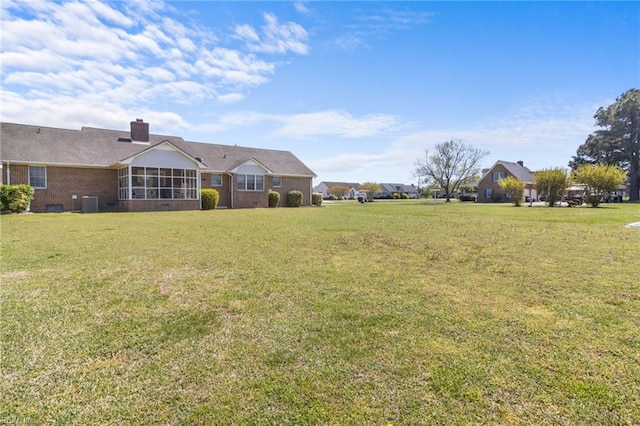 view of yard with a sunroom