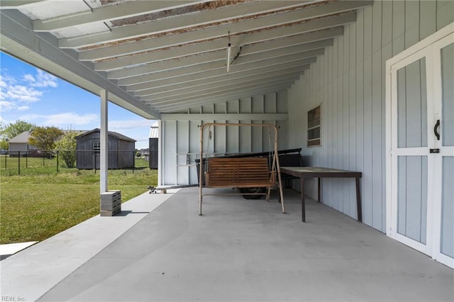 view of patio / terrace with a shed, a pergola, an outdoor structure, a carport, and fence