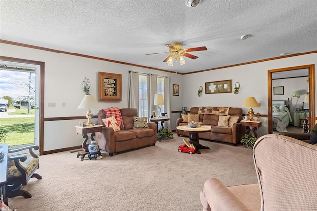 carpeted living area featuring crown molding, baseboards, a ceiling fan, and a textured ceiling