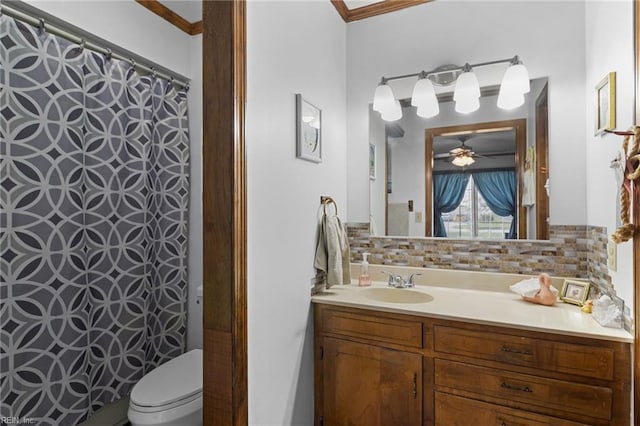 bathroom featuring vanity, crown molding, toilet, and decorative backsplash