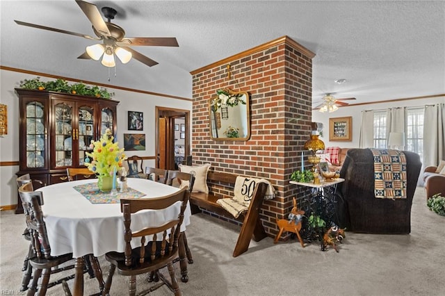 carpeted dining area featuring ornamental molding, ceiling fan, vaulted ceiling, and a textured ceiling