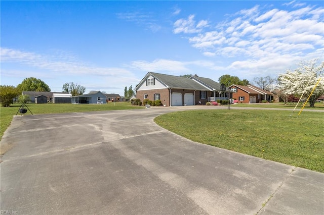 view of front of home with a front yard, curved driveway, an attached garage, and a residential view