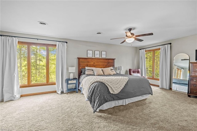 bedroom featuring visible vents, multiple windows, and carpet