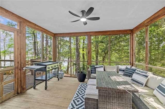 sunroom featuring a ceiling fan and an outdoor hangout area