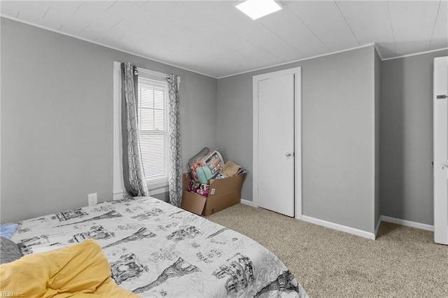 carpeted bedroom featuring baseboards and ornamental molding