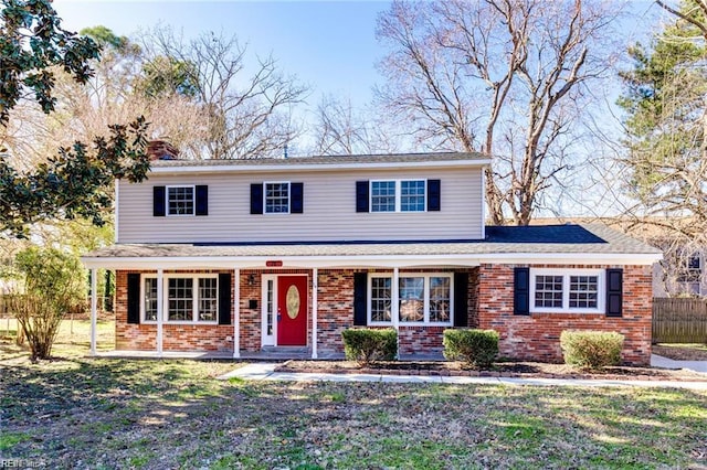 78 Kendall Dr, Newport News, VA 23601 - traditional-style home with covered porch, fence, a front lawn, brick siding, and a chimney