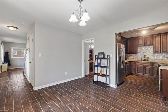 78 Kendall Dr, Newport News, VA 23601 - kitchen with a sink, stainless steel fridge, baseboards, a notable chandelier, and dark wood-type flooring