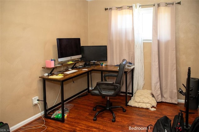 home office featuring wood finished floors and baseboards