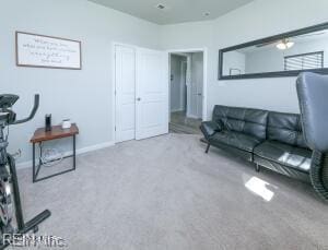 living room featuring baseboards and carpet floors