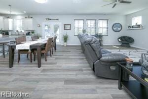 interior space featuring ceiling fan, wood finished floors, and baseboards