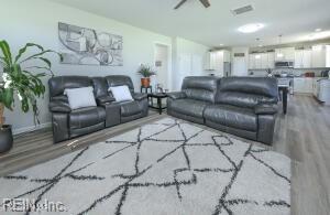 living room featuring wood finished floors and baseboards