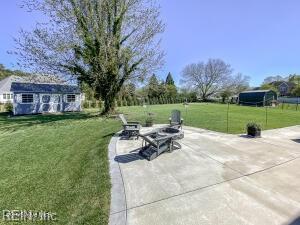 view of patio featuring an outbuilding