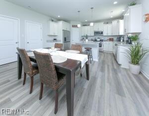 dining room featuring recessed lighting and light wood-type flooring