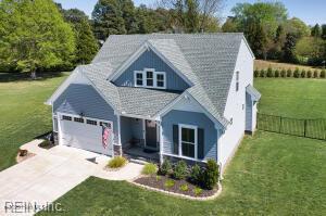 craftsman inspired home featuring fence, a garage, a front yard, and concrete driveway