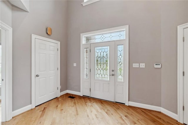 89 Sandy Bay Dr, Poquoson, VA 23662 - entrance foyer featuring baseboards, a towering ceiling, visible vents, and light wood-style flooring