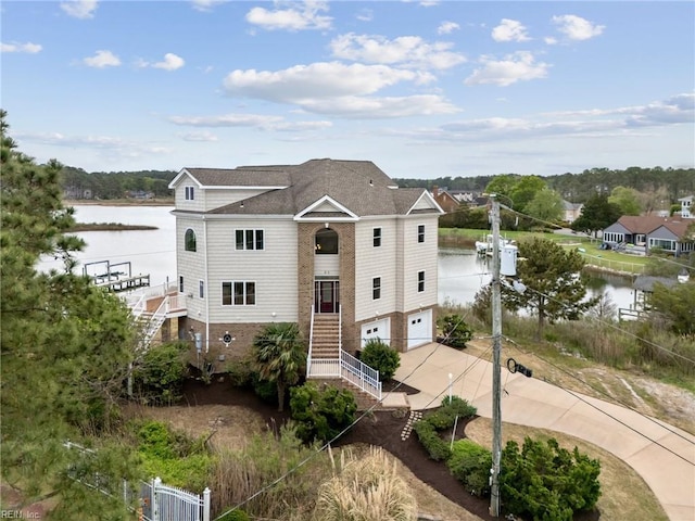 89 Sandy Bay Dr, Poquoson, VA 23662 - view of front of home featuring an attached garage, driveway, stairs, and a water view