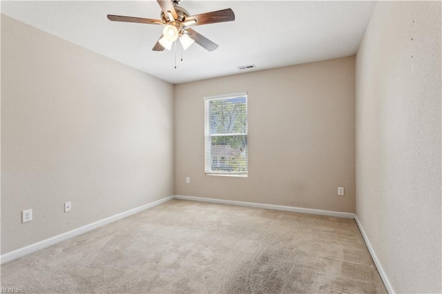unfurnished room featuring visible vents, carpet flooring, baseboards, and ceiling fan