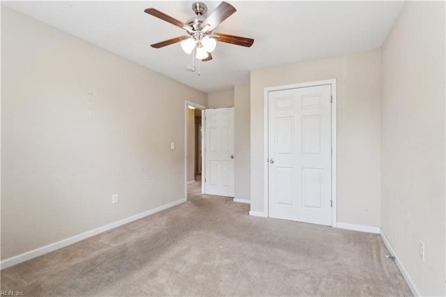unfurnished bedroom featuring baseboards, carpet, and ceiling fan