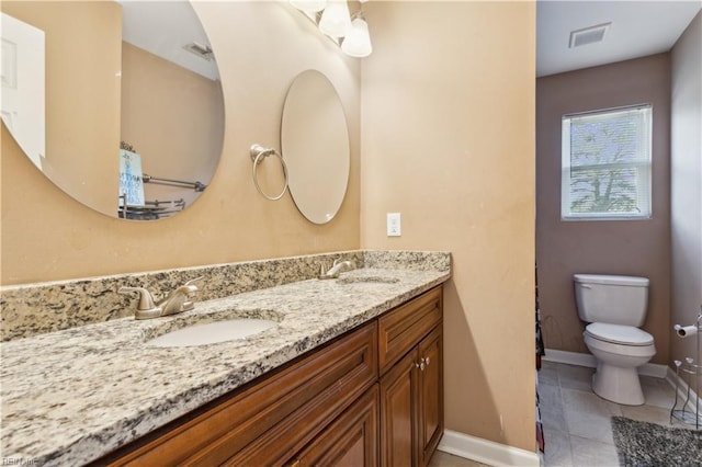 full bathroom with toilet, tile patterned flooring, a sink, and double vanity
