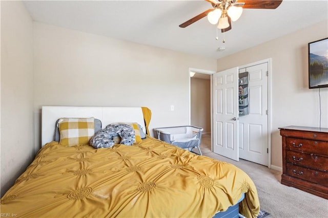 carpeted bedroom featuring baseboards and a ceiling fan