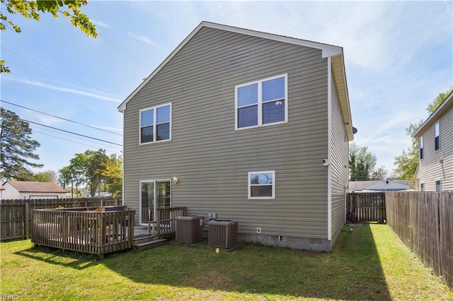 back of property with a yard, central air condition unit, a fenced backyard, and a deck