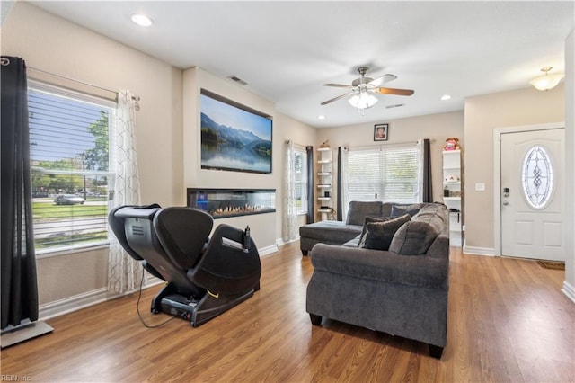 living room with wood finished floors, ceiling fan, baseboards, visible vents, and recessed lighting