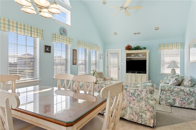 206 E Palmetto St, Kill Devil Hills, NC 27948 - dining space featuring high vaulted ceiling, light tile patterned floors, visible vents, and ceiling fan with notable chandelier
