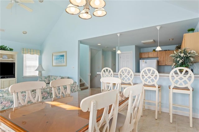 206 E Palmetto St, Kill Devil Hills, NC 27948 - dining room with high vaulted ceiling, stairs, a notable chandelier, and baseboards