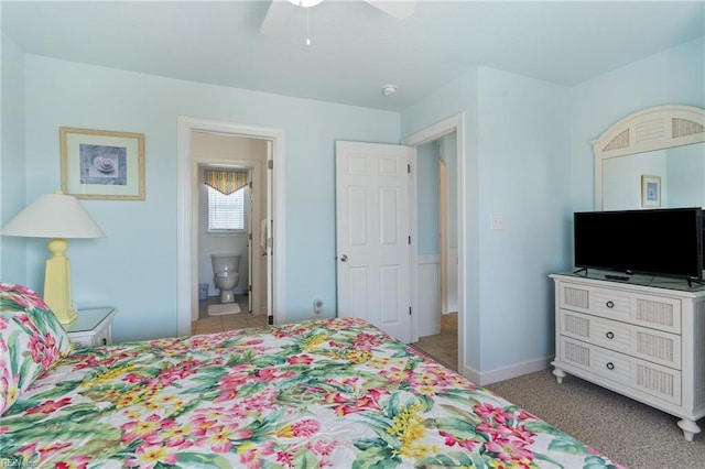 206 E Palmetto St, Kill Devil Hills, NC 27948 - bedroom featuring baseboards, a ceiling fan, and ensuite bath