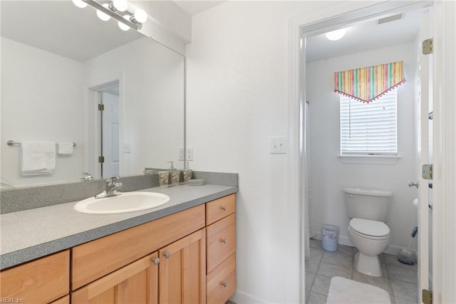 206 E Palmetto St, Kill Devil Hills, NC 27948 - bathroom with tile patterned flooring, vanity, baseboards, and toilet