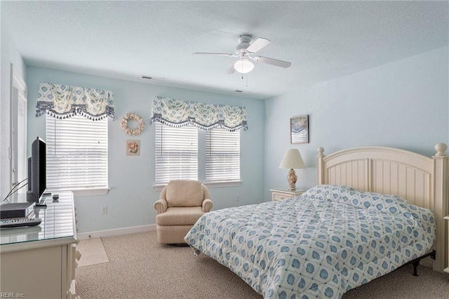 206 E Palmetto St, Kill Devil Hills, NC 27948 - bedroom with visible vents, baseboards, a ceiling fan, and light carpet