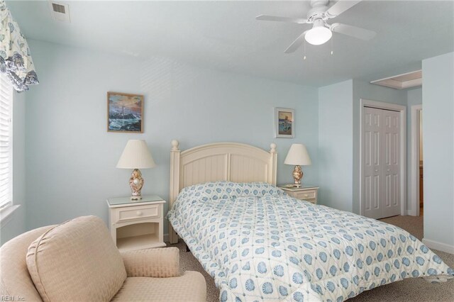 206 E Palmetto St, Kill Devil Hills, NC 27948 - bedroom featuring baseboards, a closet, carpet flooring, a ceiling fan, and visible vents