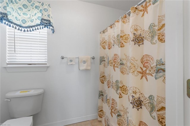 206 E Palmetto St, Kill Devil Hills, NC 27948 - full bathroom featuring toilet, a shower with shower curtain, baseboards, and tile patterned flooring