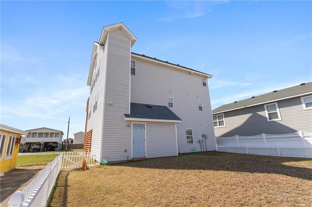 206 E Palmetto St, Kill Devil Hills, NC 27948 - back of property with a yard, a fenced backyard, and a chimney