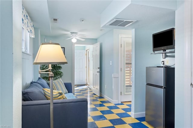 206 E Palmetto St, Kill Devil Hills, NC 27948 - living area with ceiling fan, baseboards, visible vents, and light floors