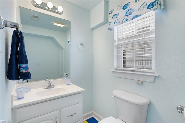 206 E Palmetto St, Kill Devil Hills, NC 27948 - bathroom featuring visible vents, toilet, and vanity