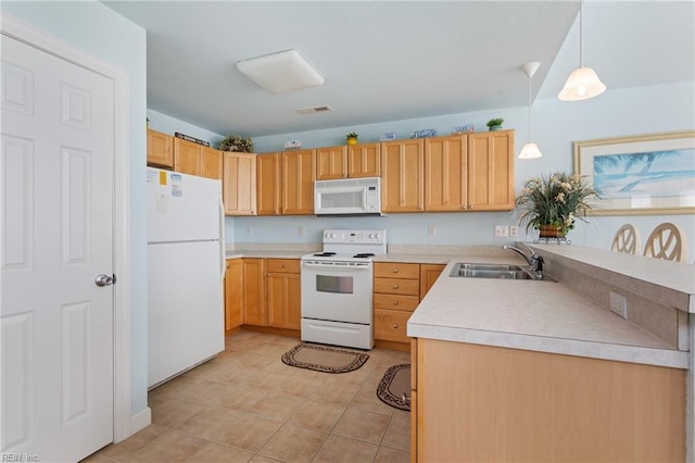206 E Palmetto St, Kill Devil Hills, NC 27948 - kitchen featuring white appliances, a peninsula, light countertops, decorative light fixtures, and a sink