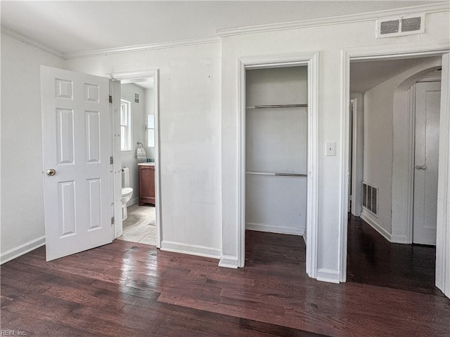 unfurnished bedroom with wood finished floors, visible vents, and ornamental molding