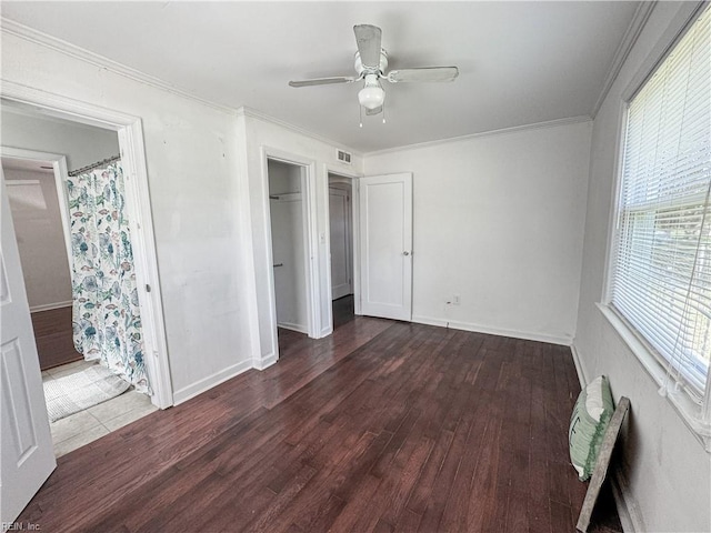 unfurnished bedroom with ceiling fan, crown molding, wood finished floors, and visible vents