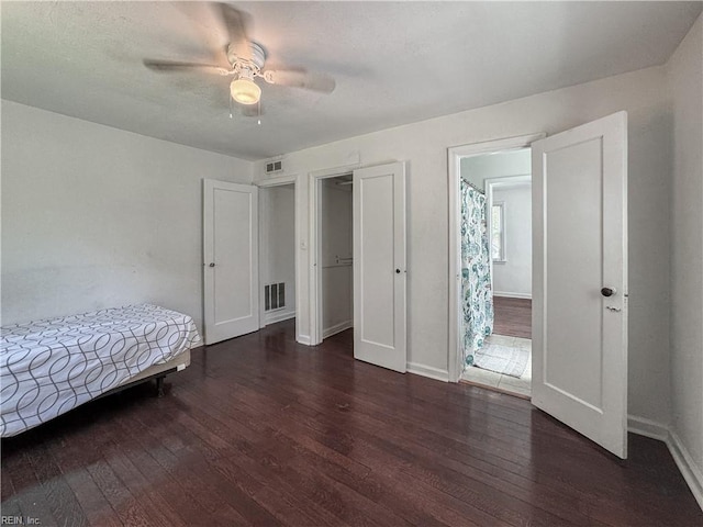 bedroom featuring wood-type flooring, visible vents, baseboards, and ceiling fan
