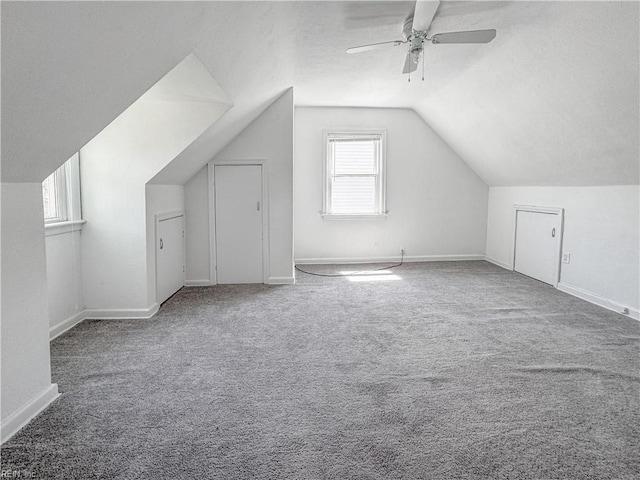 bonus room featuring lofted ceiling, a ceiling fan, carpet flooring, and baseboards