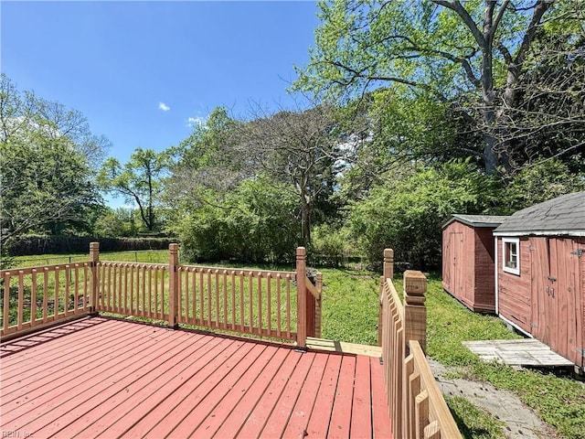 deck featuring a lawn, an outbuilding, and a shed