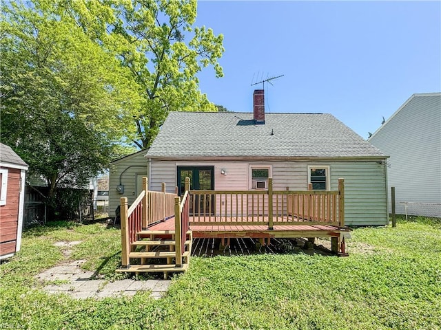 back of property featuring fence, a shingled roof, a chimney, and a deck