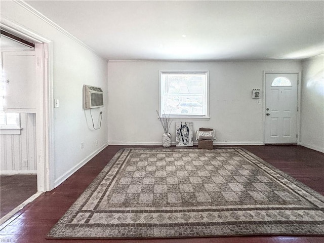 entryway featuring crown molding, dark wood-style flooring, baseboards, and a wall mounted air conditioner
