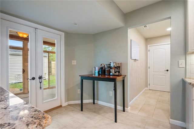 doorway featuring visible vents, baseboards, and french doors